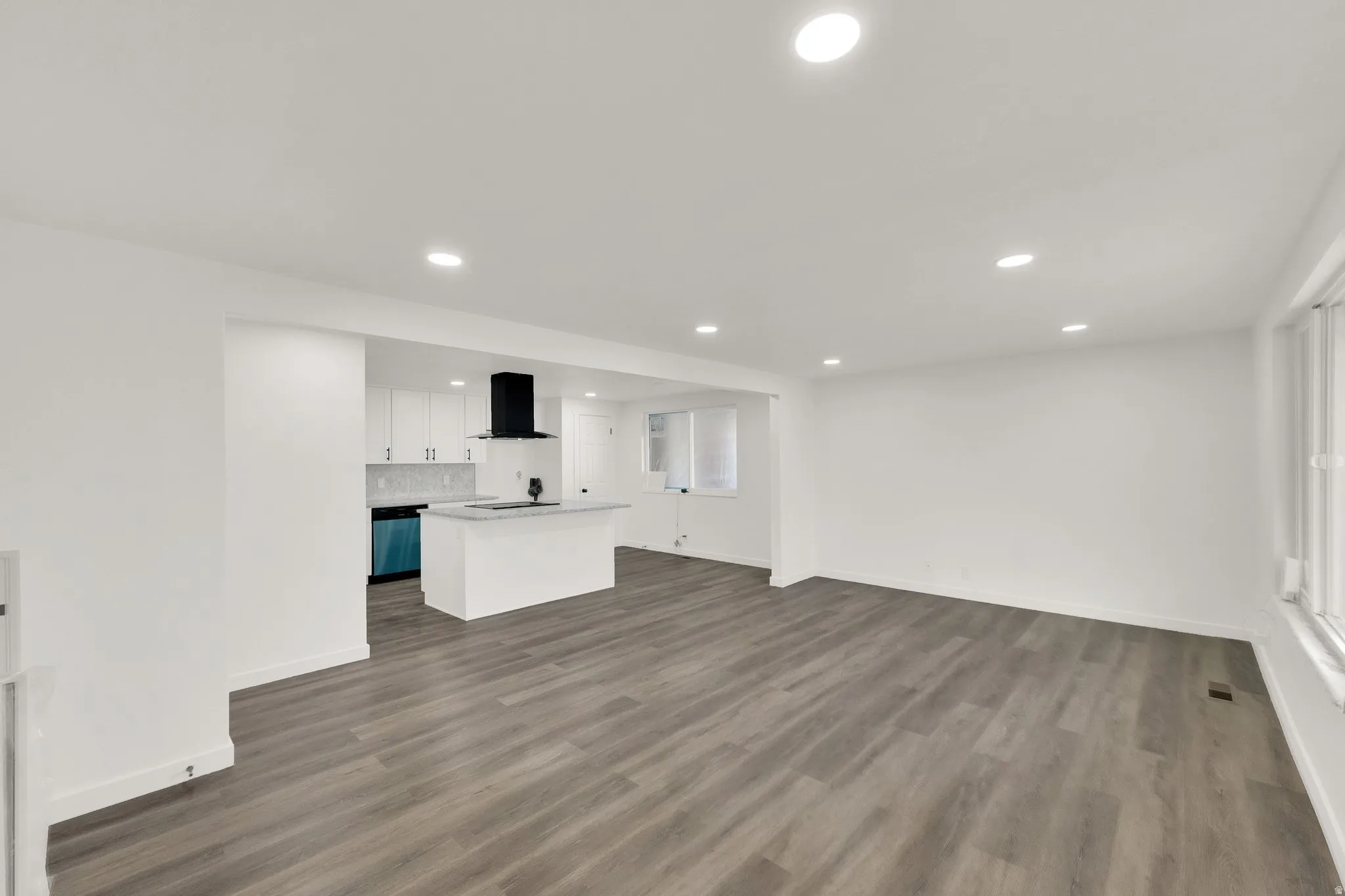 Spacious interior featuring wood-finish flooring and recessed lighting throughout
