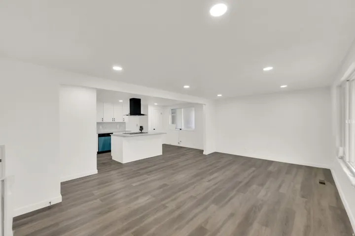 Spacious interior featuring wood-finish flooring and recessed lighting throughout