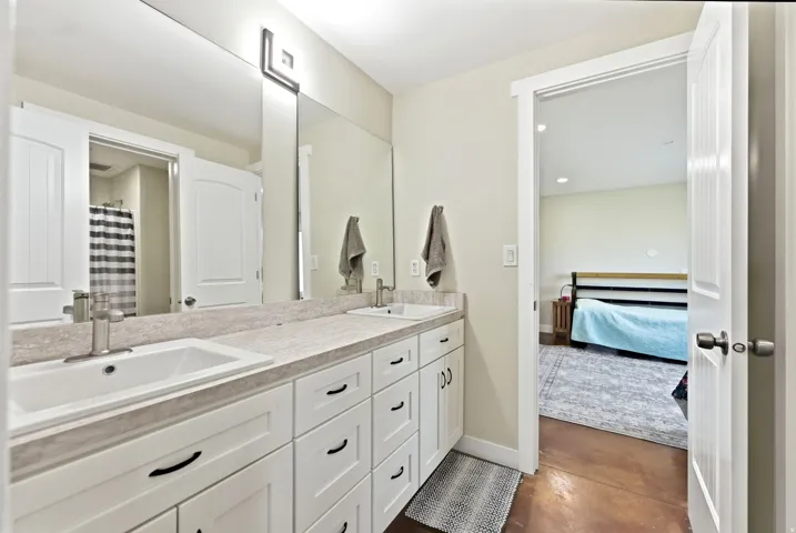 Dual vanity with white cabinetry, light-toned countertop, and undermount sinks