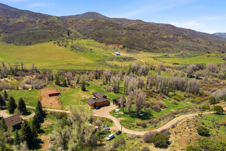 Expansive property featuring a multi-structure layout with a main residence and additional outbuildings