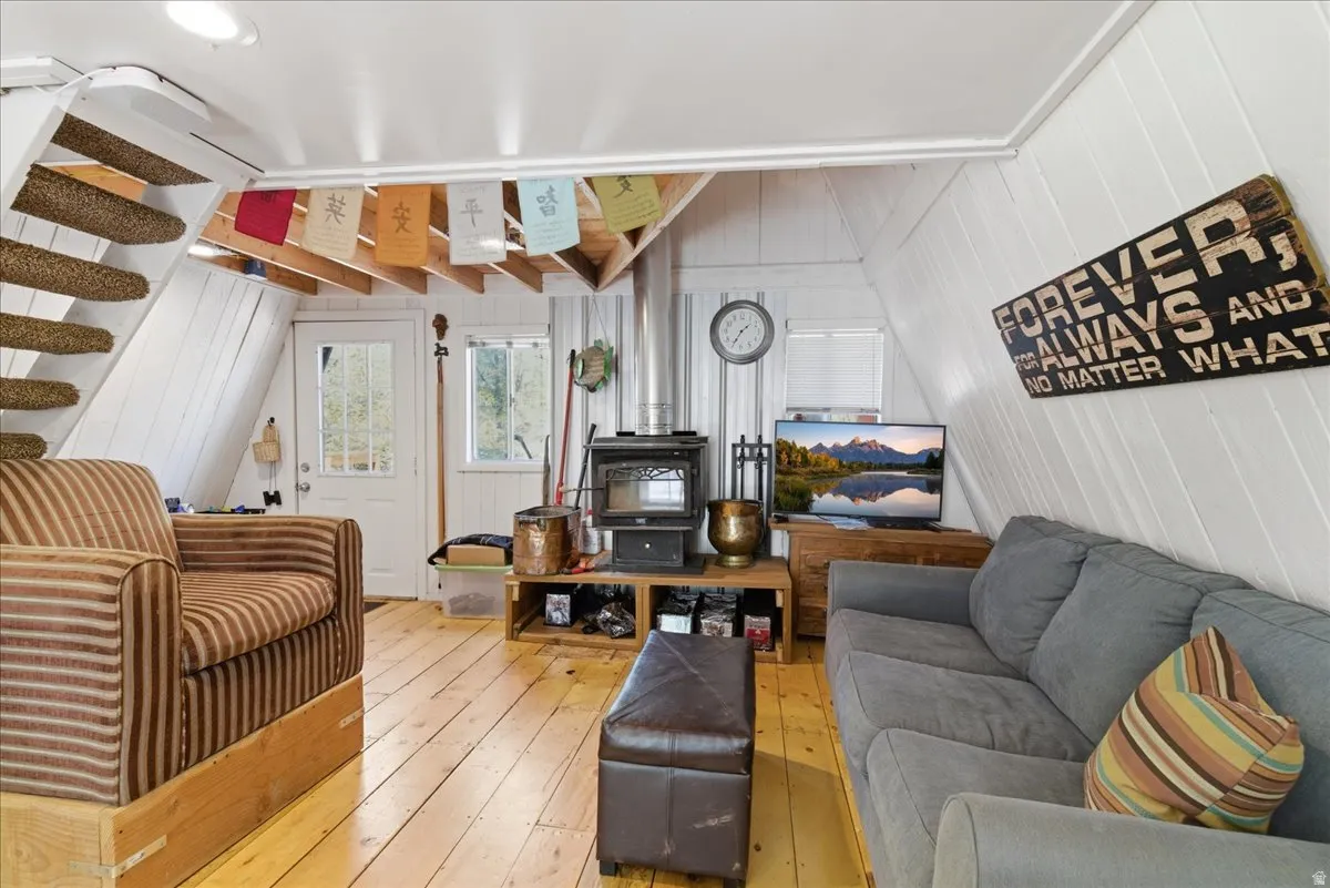 Bright living area featuring wood-finish flooring and white paneled walls
