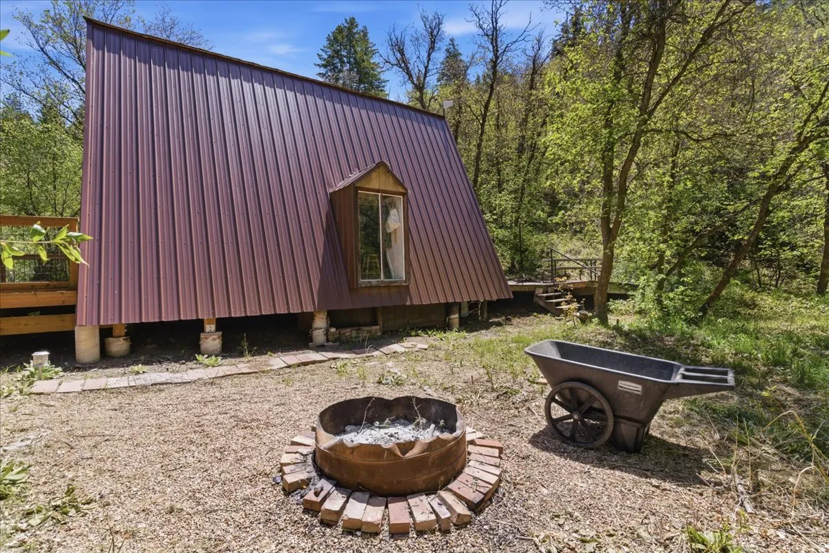 A-frame structure with a metal roof and a prominent dormer window