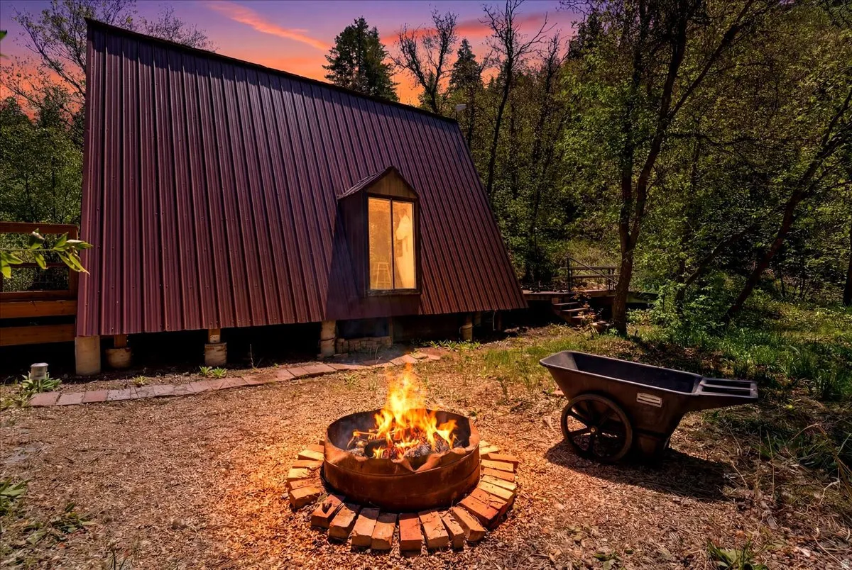 A-frame structure with metal panel siding and a prominent dormer window