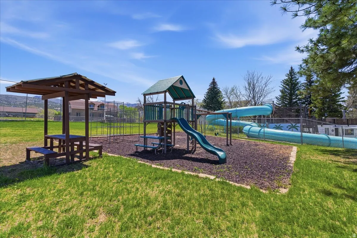 On-site playground featuring multiple slides, climbing structure, and dedicated play surface