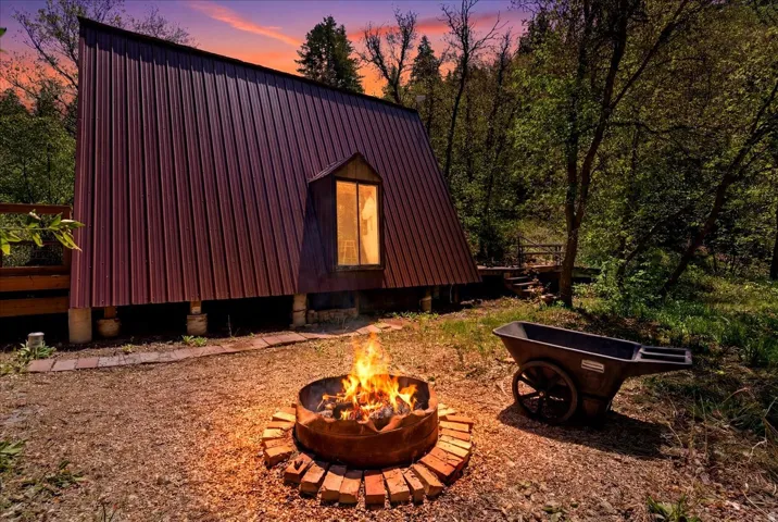 A-frame structure with metal panel siding and a prominent dormer window