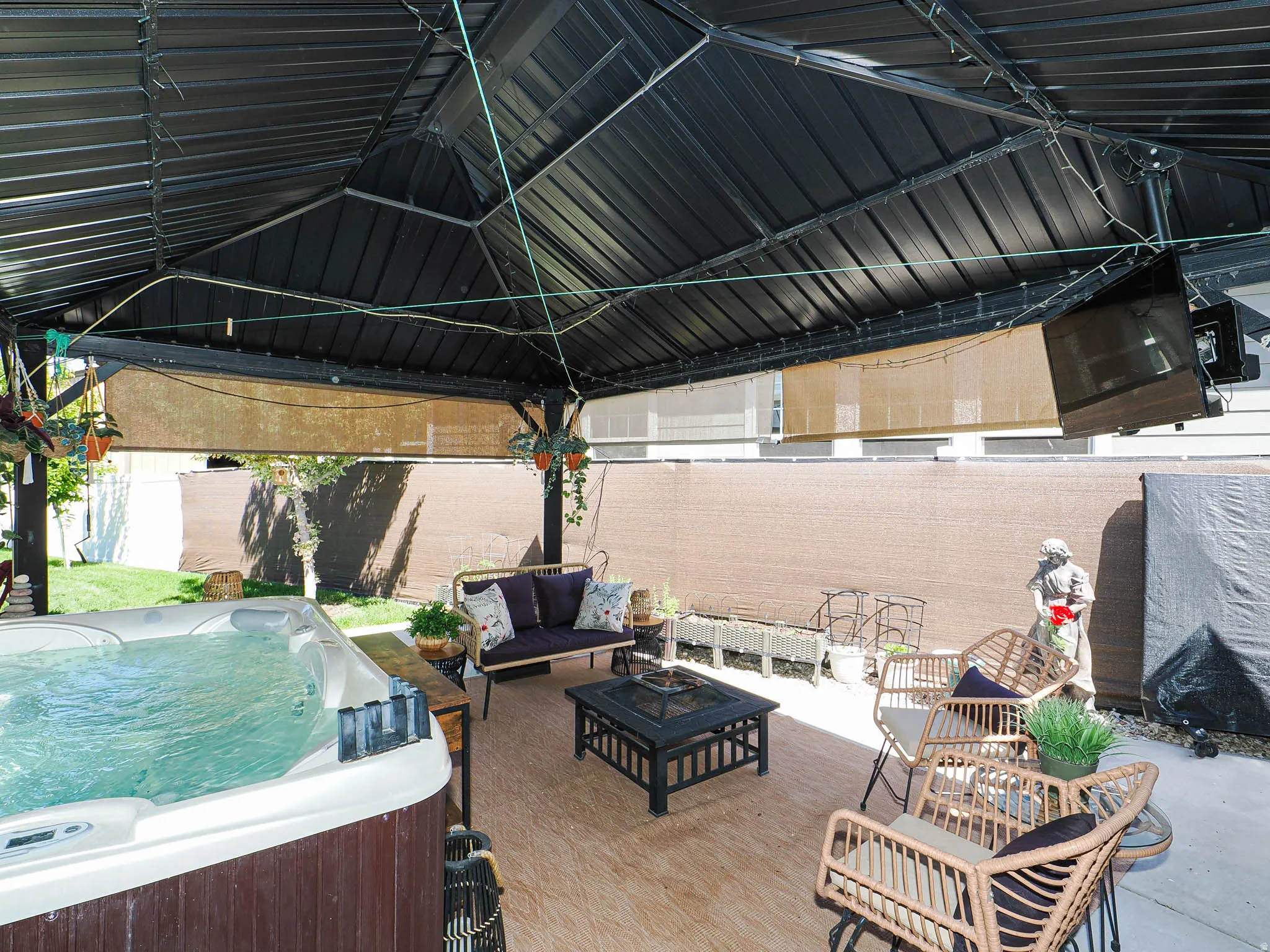 Patio off family room with hot tub and TV.