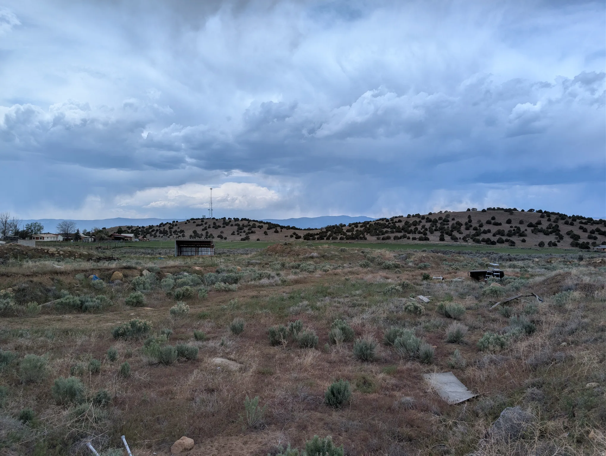 Expansive natural landscape featuring rolling hills and distant mountains