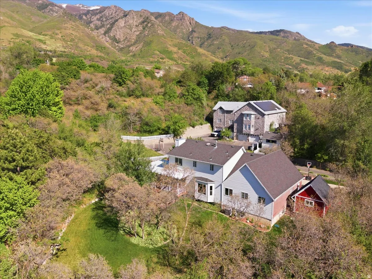 Expansive hillside property featuring multiple structures and natural surroundings