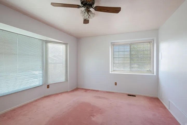 Room with bay window and an additional window