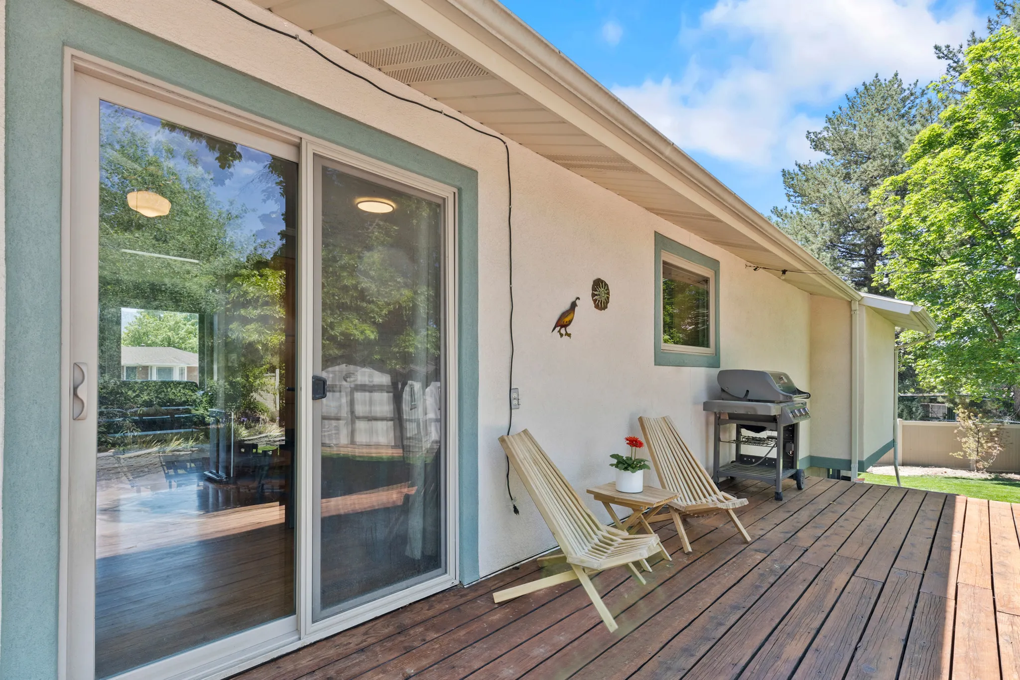 Spacious wood-finish deck with stucco exterior