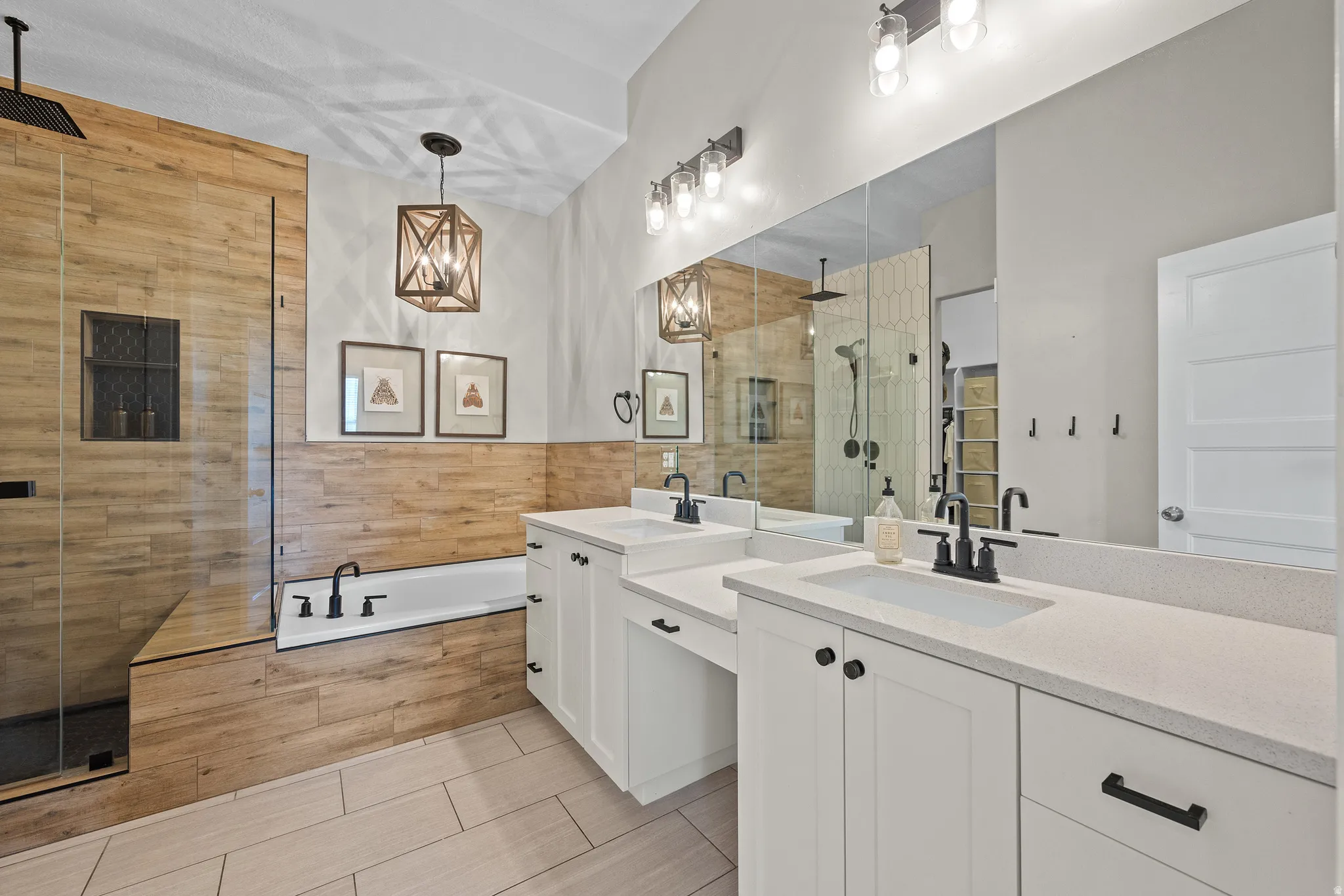 Dual vanity featuring undermount sinks, stone countertops, and matte black fixtures