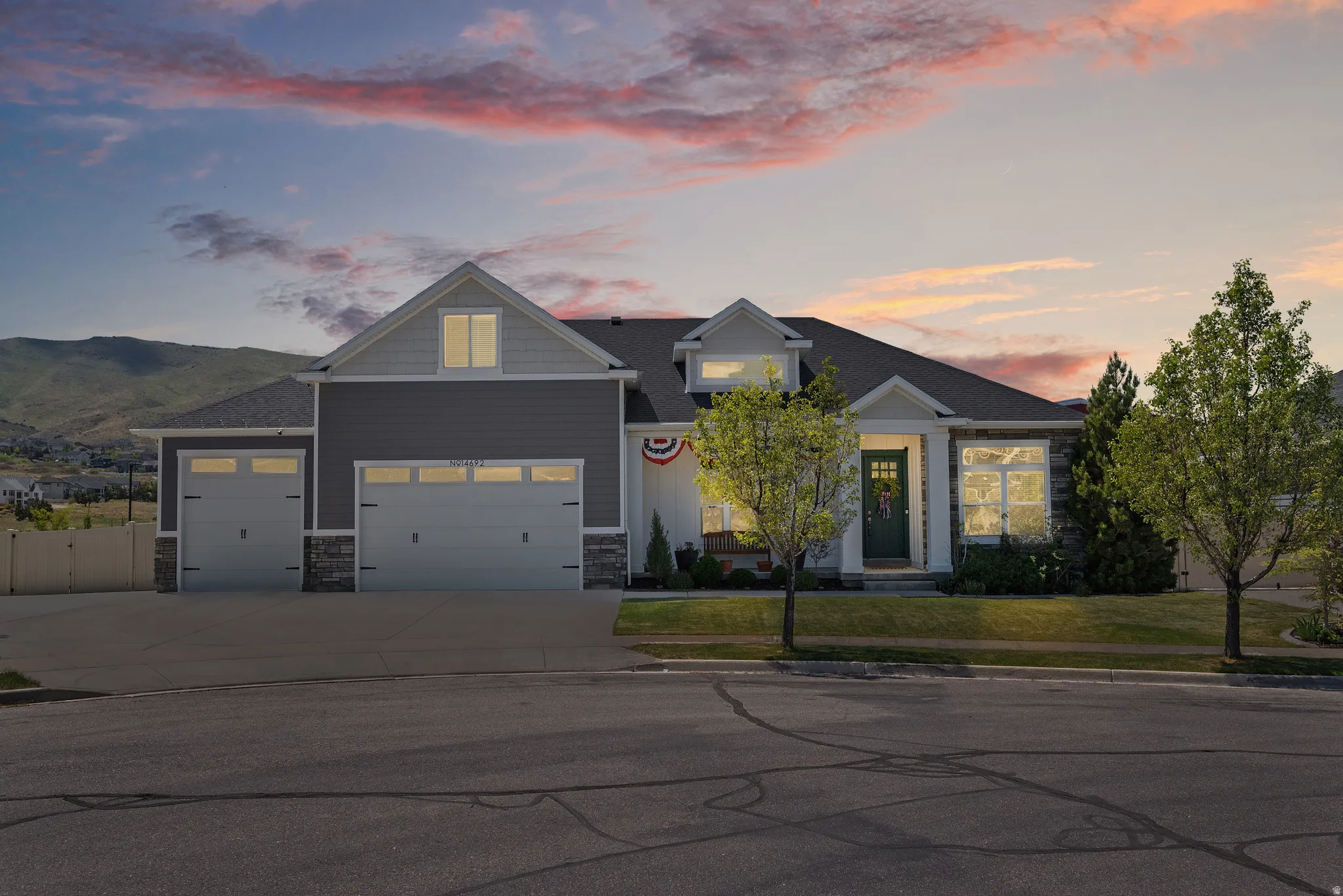 Modern ranch-style residence featuring a gray and white siding exterior