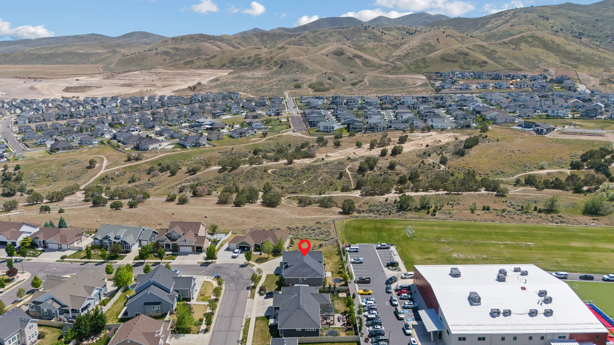 Aerial perspective showcasing a residential area set against a mountainous backdrop