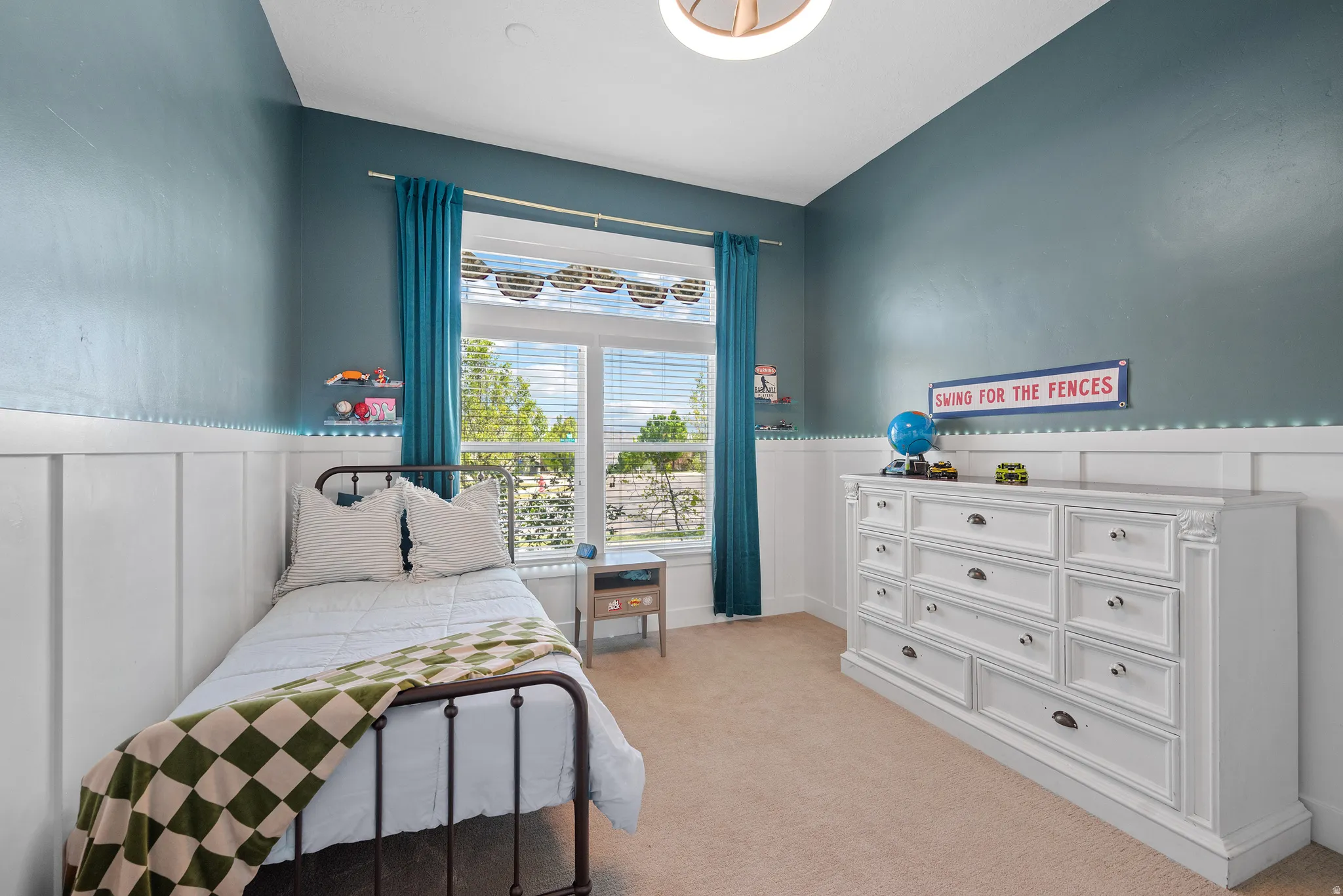 Bedroom featuring board and batten wall paneling, a large window with blinds, and recessed lighting