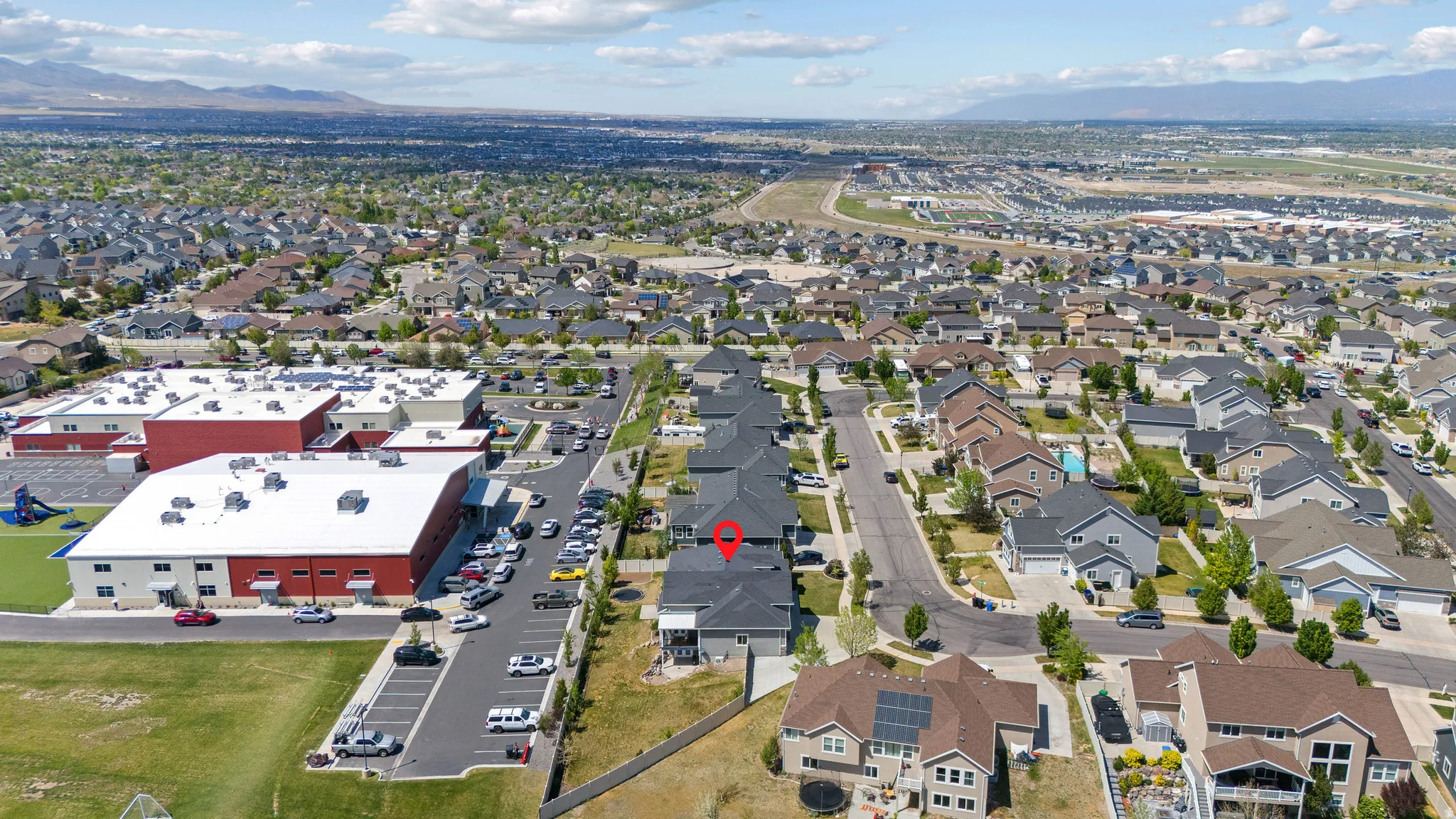 Aerial perspective showcasing a residential neighborhood with distant mountain ranges