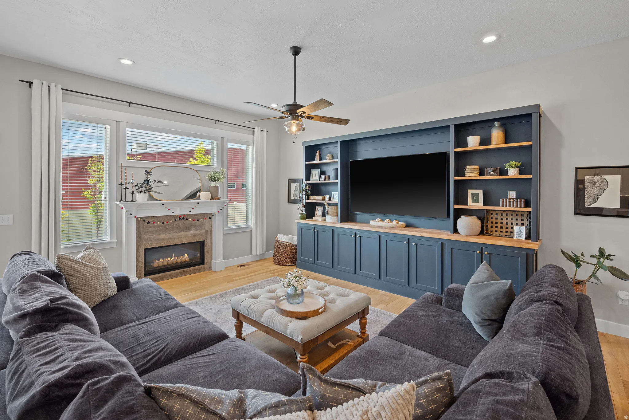 Living space featuring light wood-finish flooring and recessed lighting