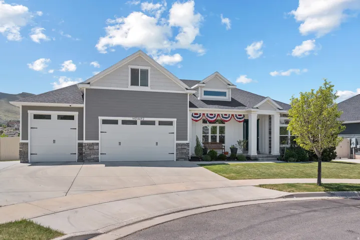 Modern exterior featuring gray siding, white trim, and stone accents