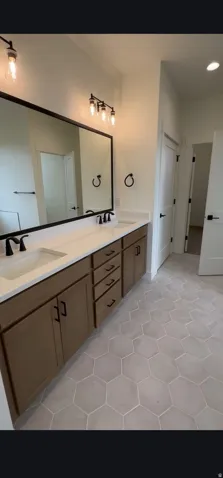 Dual vanity with white countertops, undermount sinks, and matte black fixtures