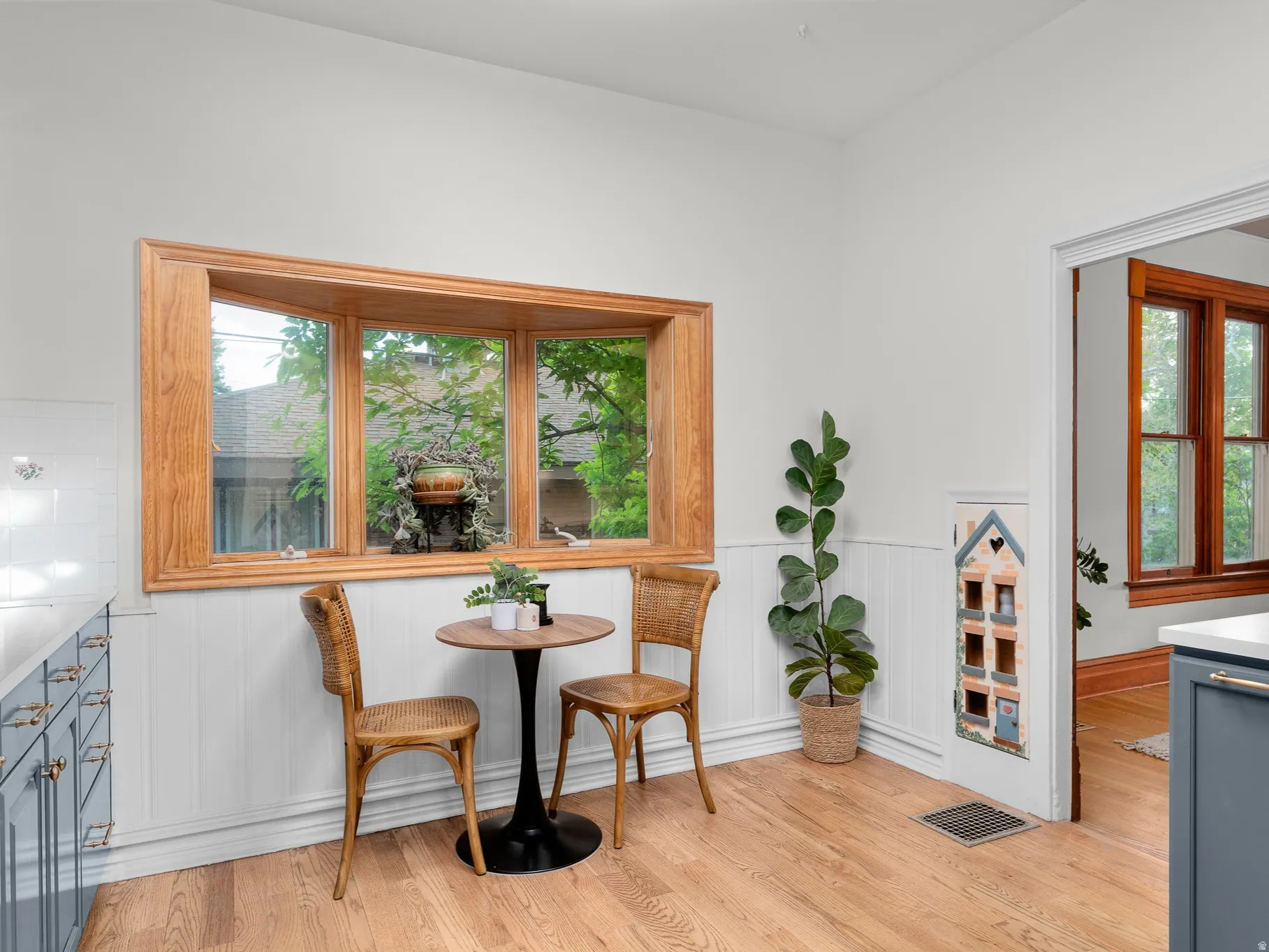 Bright interior space featuring a prominent wood-framed bay window
