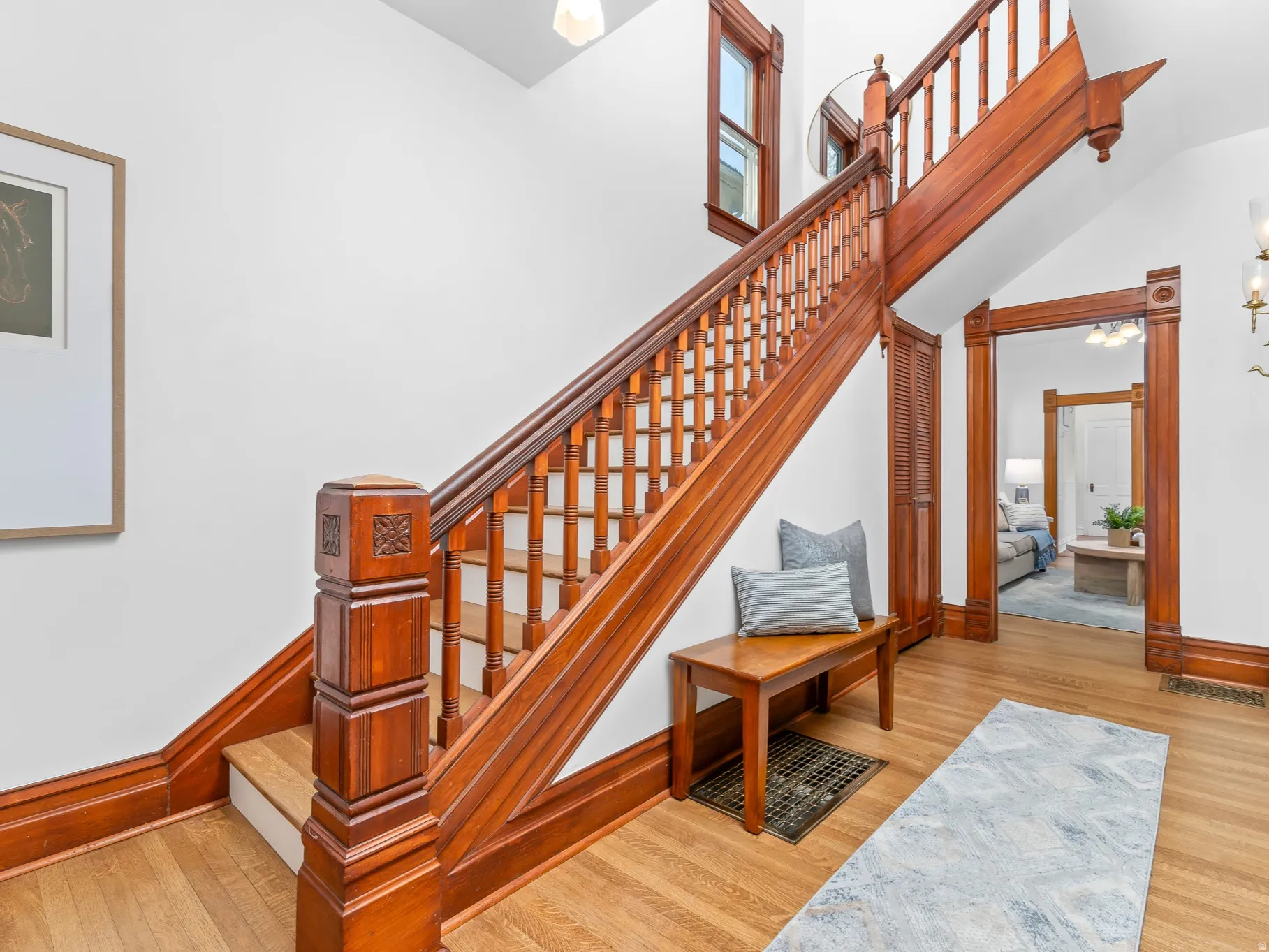 Hardwood staircase featuring carved newel posts and balusters