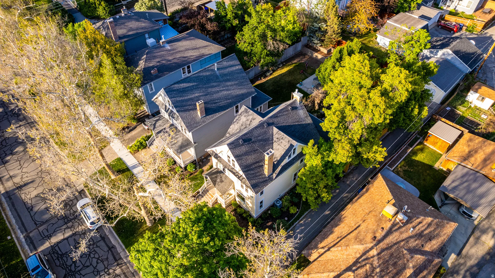 Aerial perspective highlighting the property's roofline, featuring a dormer window and two brick chimneys