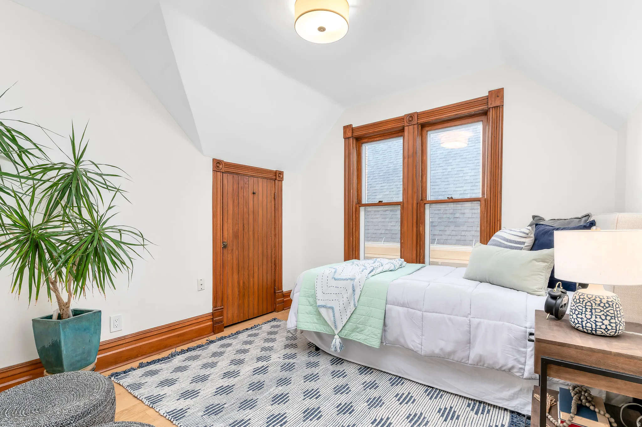 Room featuring wood-finish flooring, white walls, and a recessed ceiling