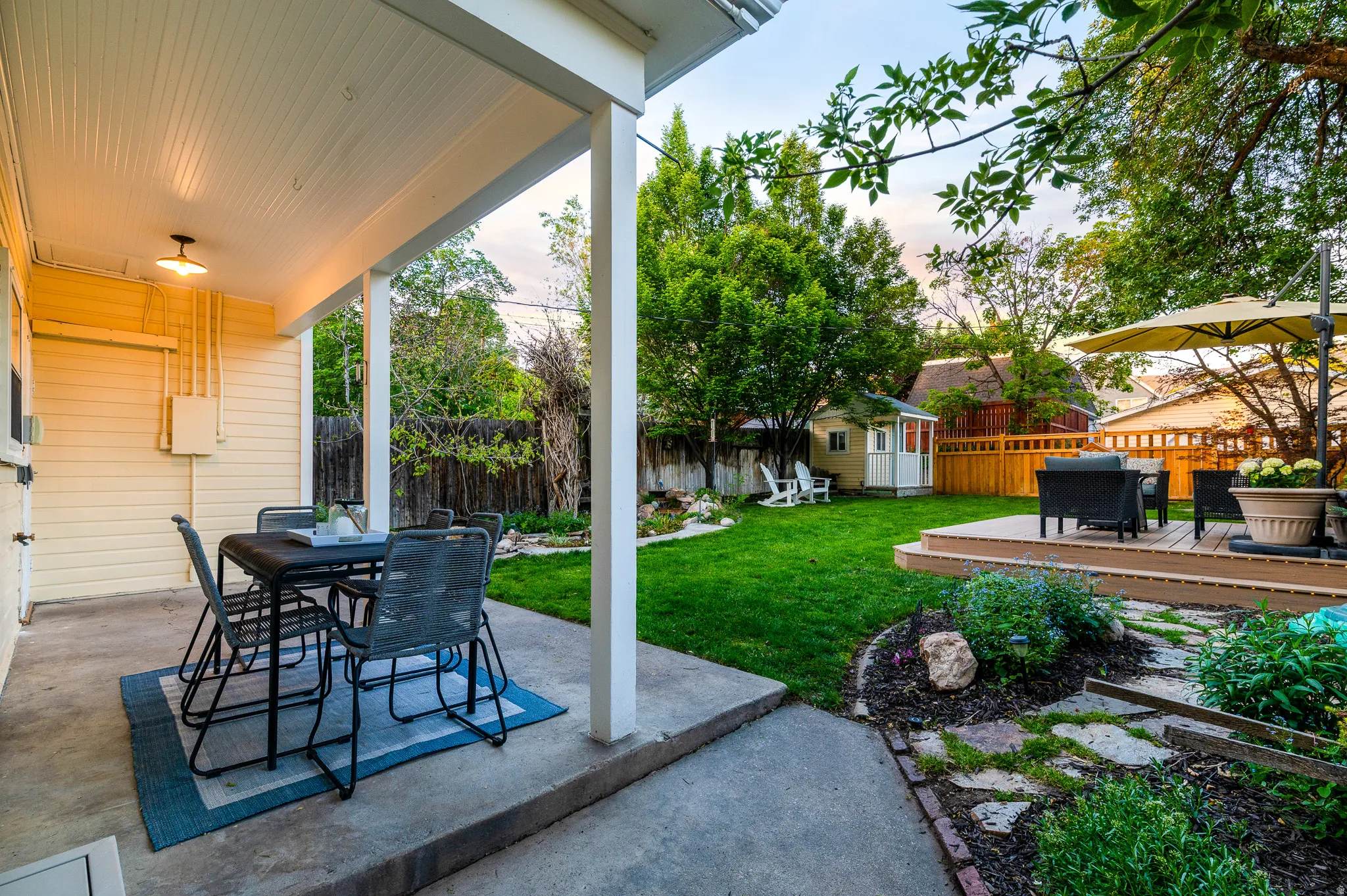 Covered patio with a beadboard ceiling and exterior lighting