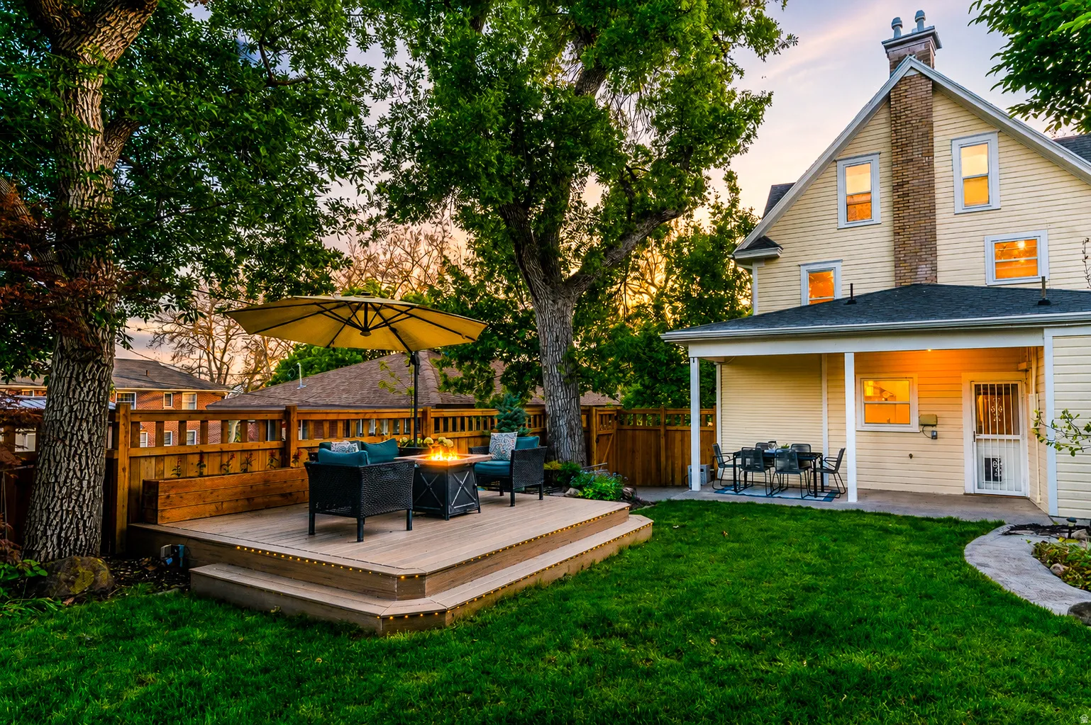 Tiered wood-finish deck with built-in fire pit