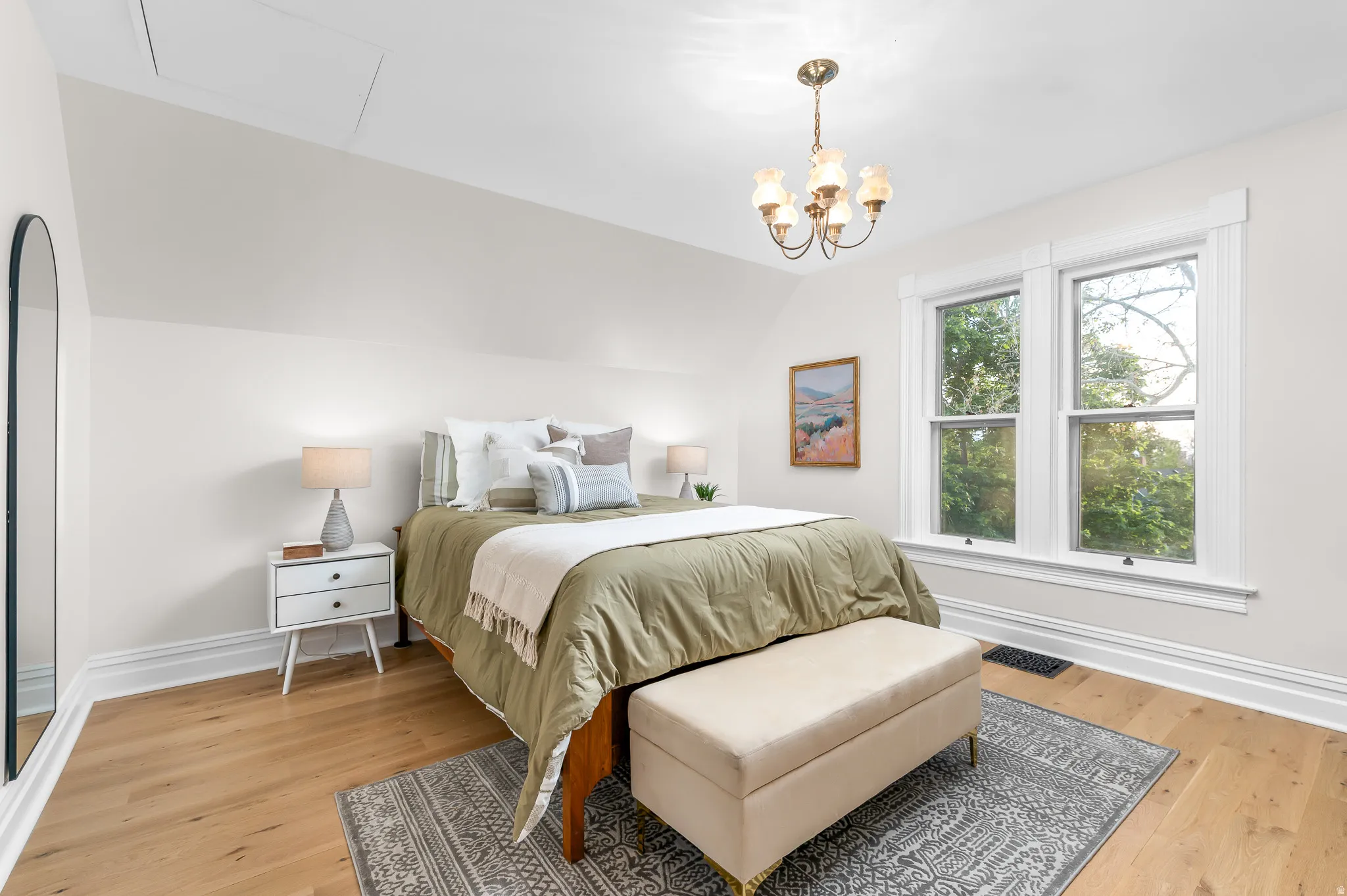 Hardwood-style flooring throughout this room with a classic chandelier