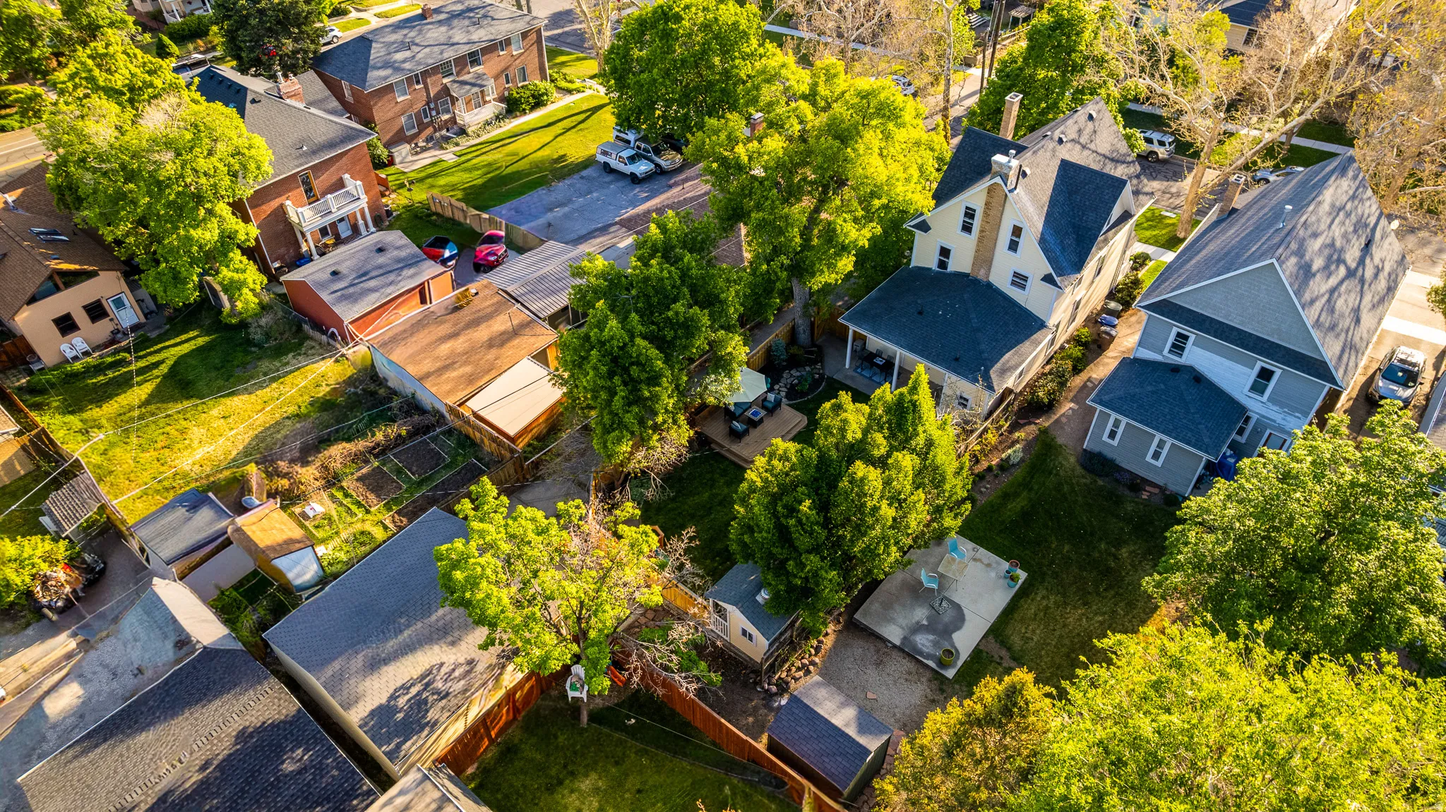 Aerial perspective showcasing multiple residential structures and surrounding green spaces