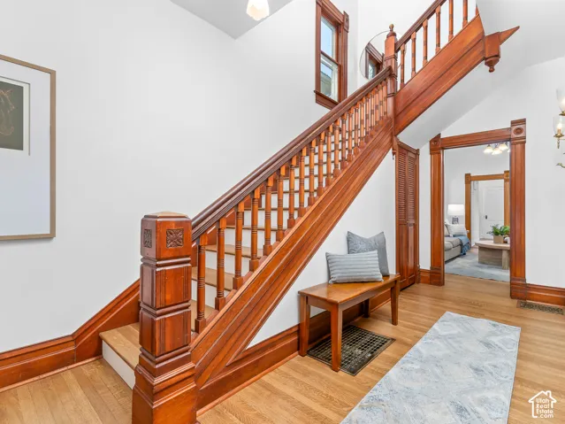 Hardwood staircase featuring carved newel posts and balusters