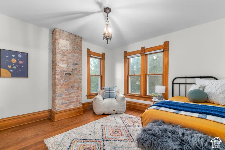 Exposed brick architectural element complemented by wood-finish flooring
