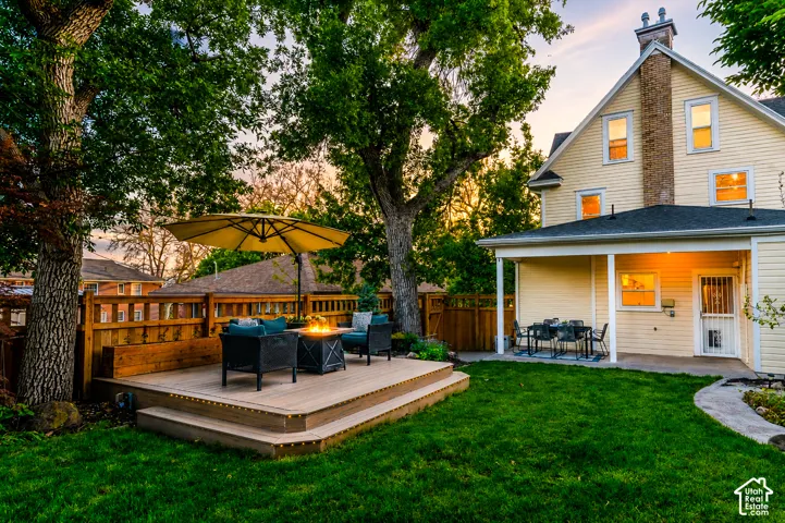 Tiered wood-finish deck with built-in fire pit