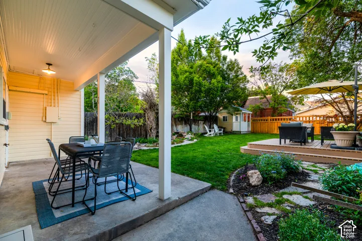 Covered patio with a beadboard ceiling and exterior lighting