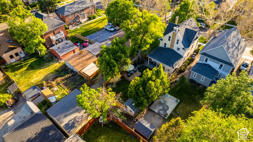 Aerial perspective showcasing multiple residential structures and surrounding green spaces