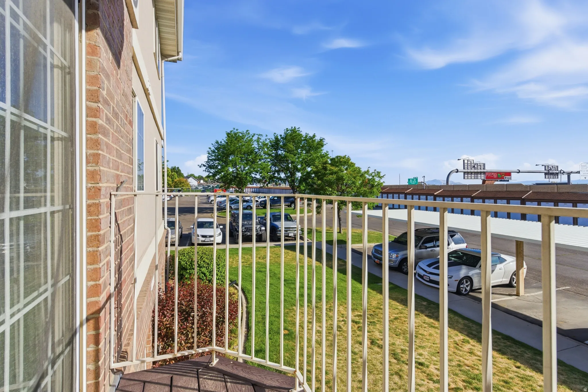 Balcony featuring metal railings and a textured floor