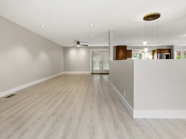 Spacious interior featuring wood-finish flooring, recessed lighting, and a contemporary ceiling fan