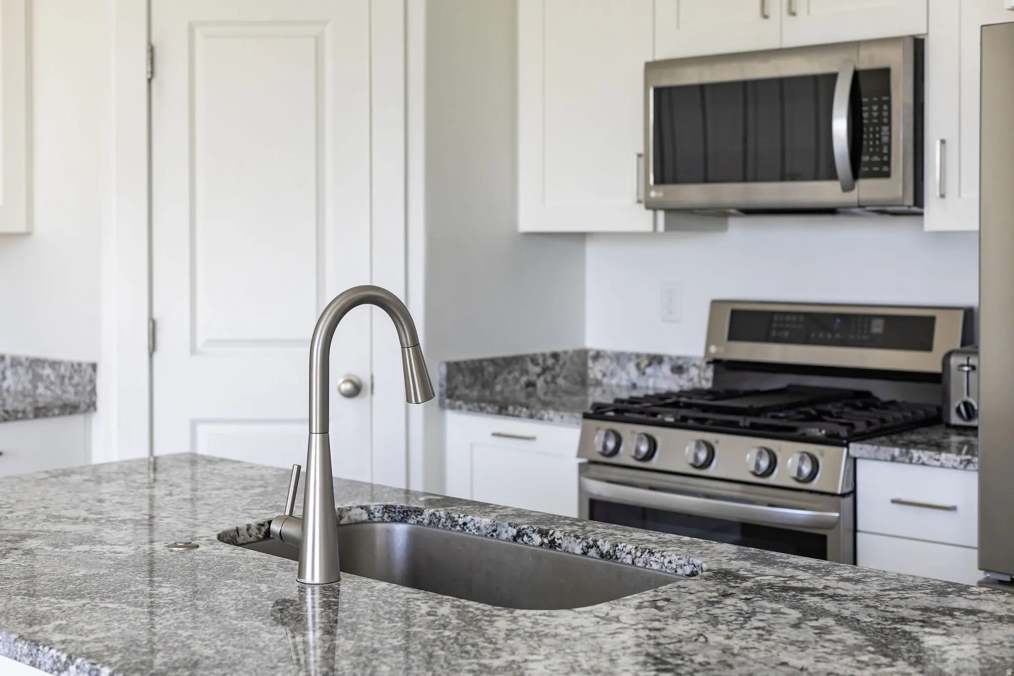 Kitchen island with integrated stainless steel sink and gooseneck faucet