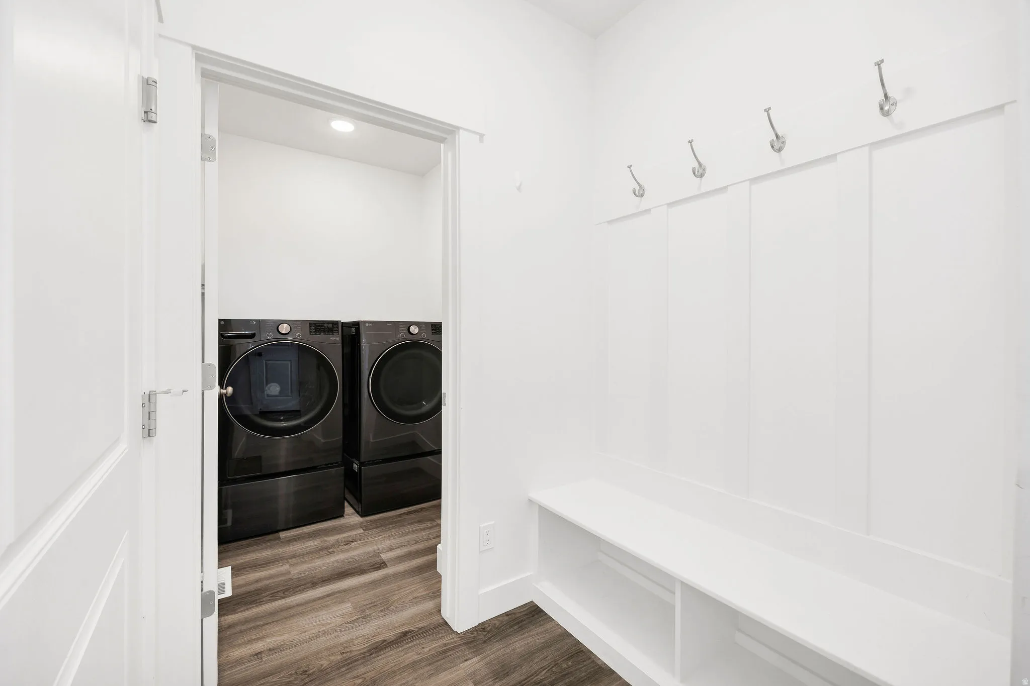 Built-in mudroom bench with storage cubbies and wall-mounted coat hooks