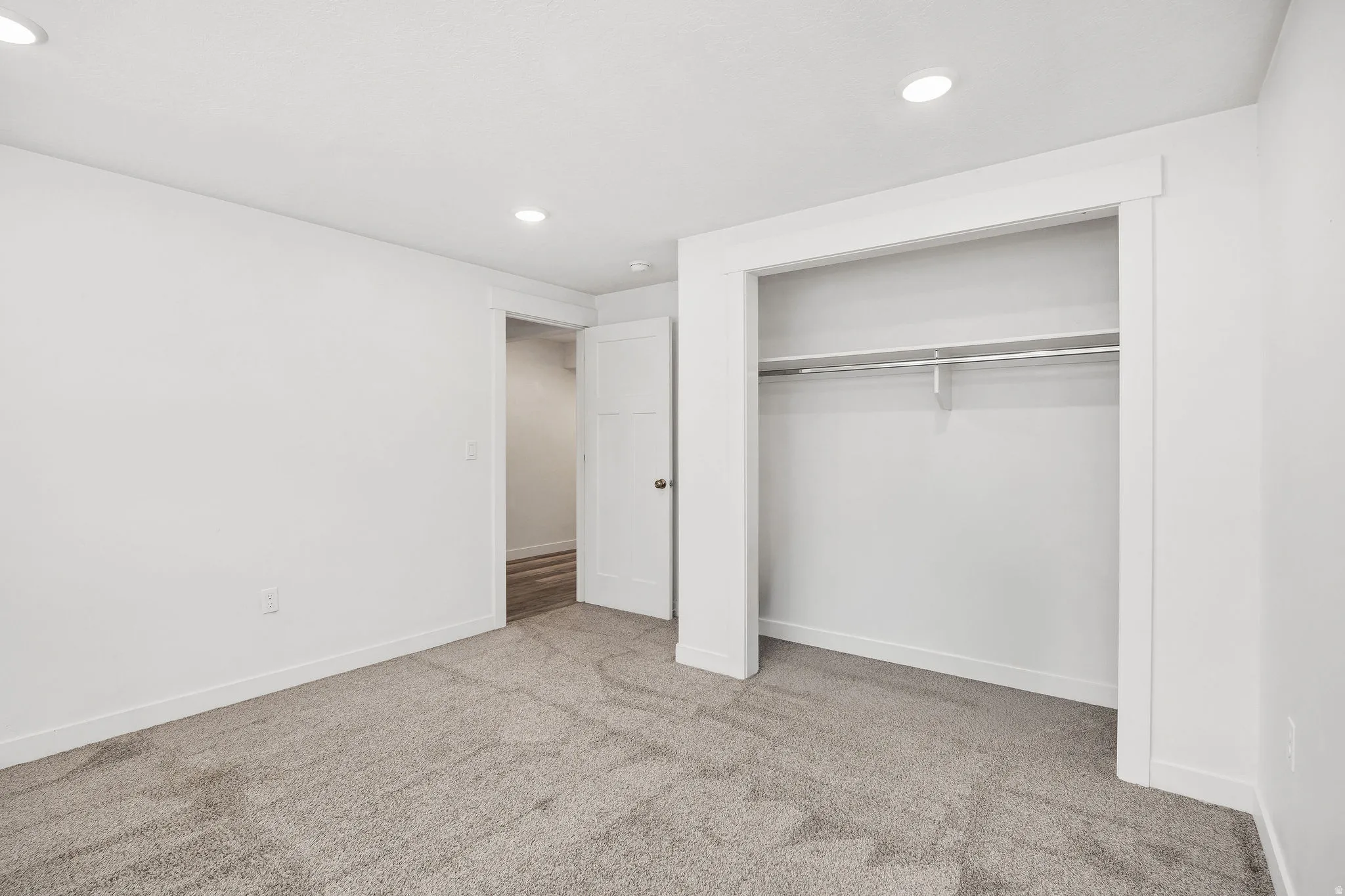 Bedroom featuring gray carpet, recessed lighting, white walls, and white trim