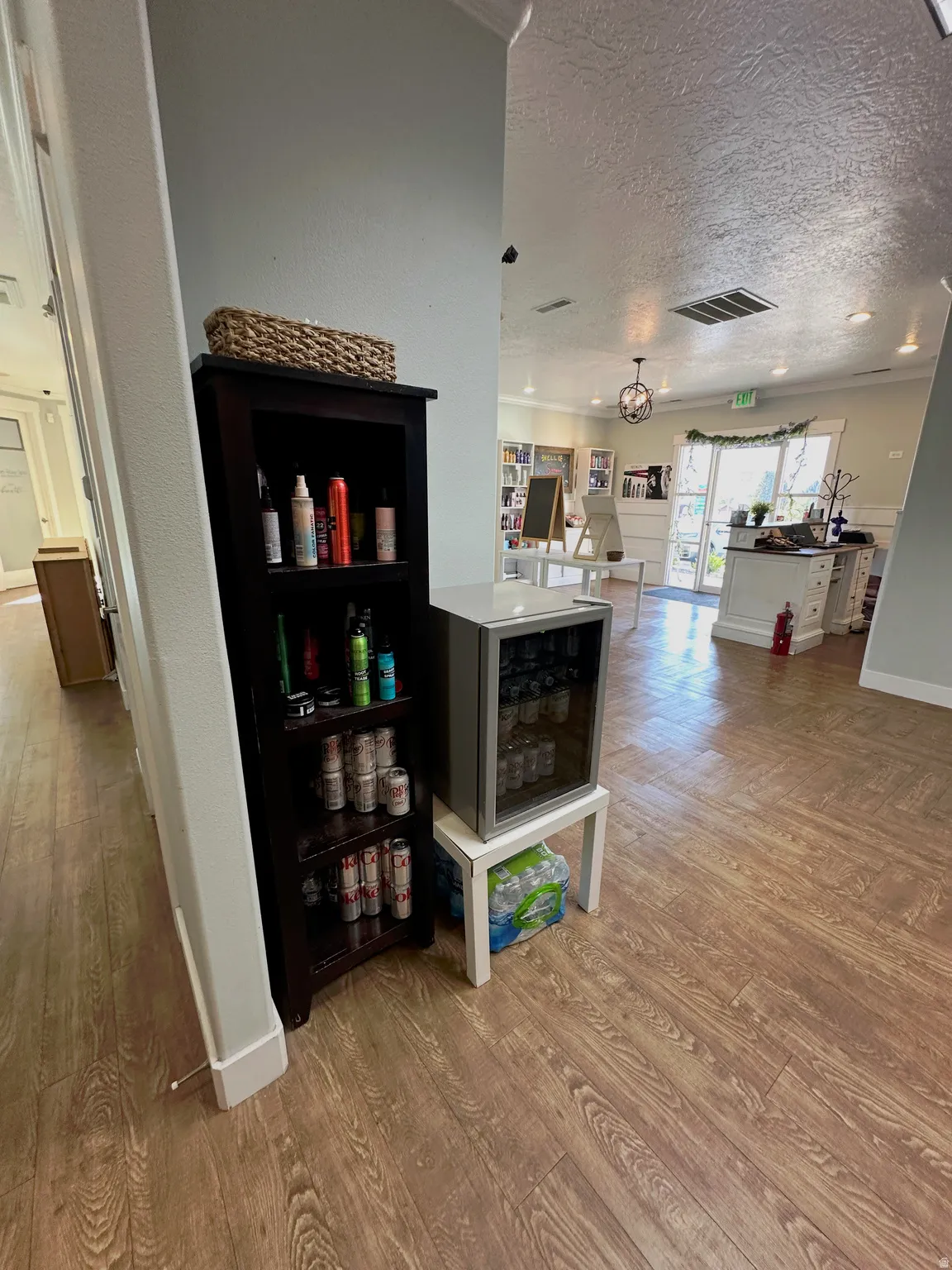 Wood-finish flooring extends throughout the space, complemented by light-toned wall paint and white baseboards