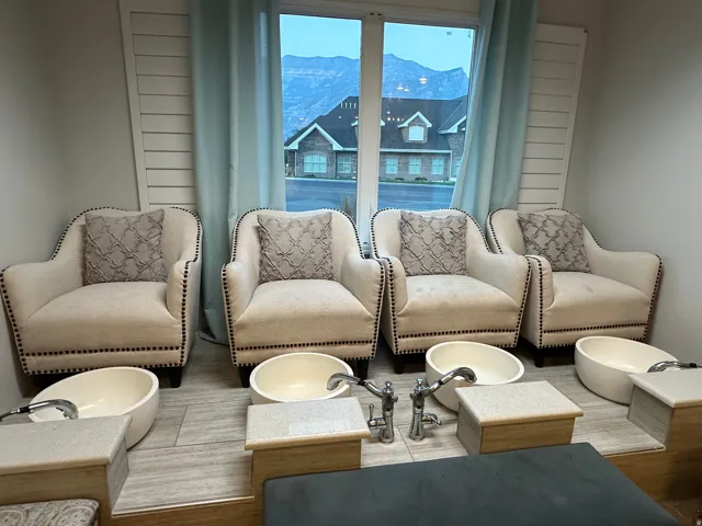 Commercial space featuring four built-in pedicure stations with individual basins and contemporary faucets