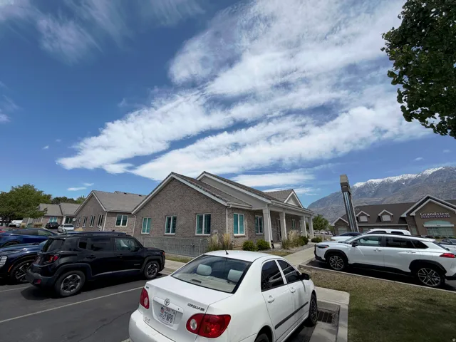 Brick exterior architecture with a gray shingle roof