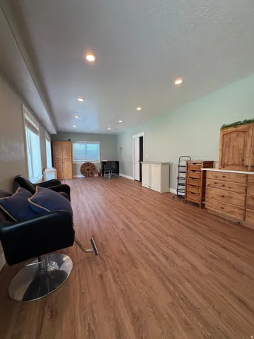 Spacious interior room featuring wood-finish flooring, recessed lighting, and light-toned walls