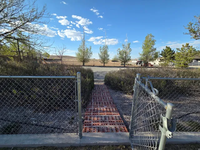 Chain-link fencing enclosing a brick paver pathway