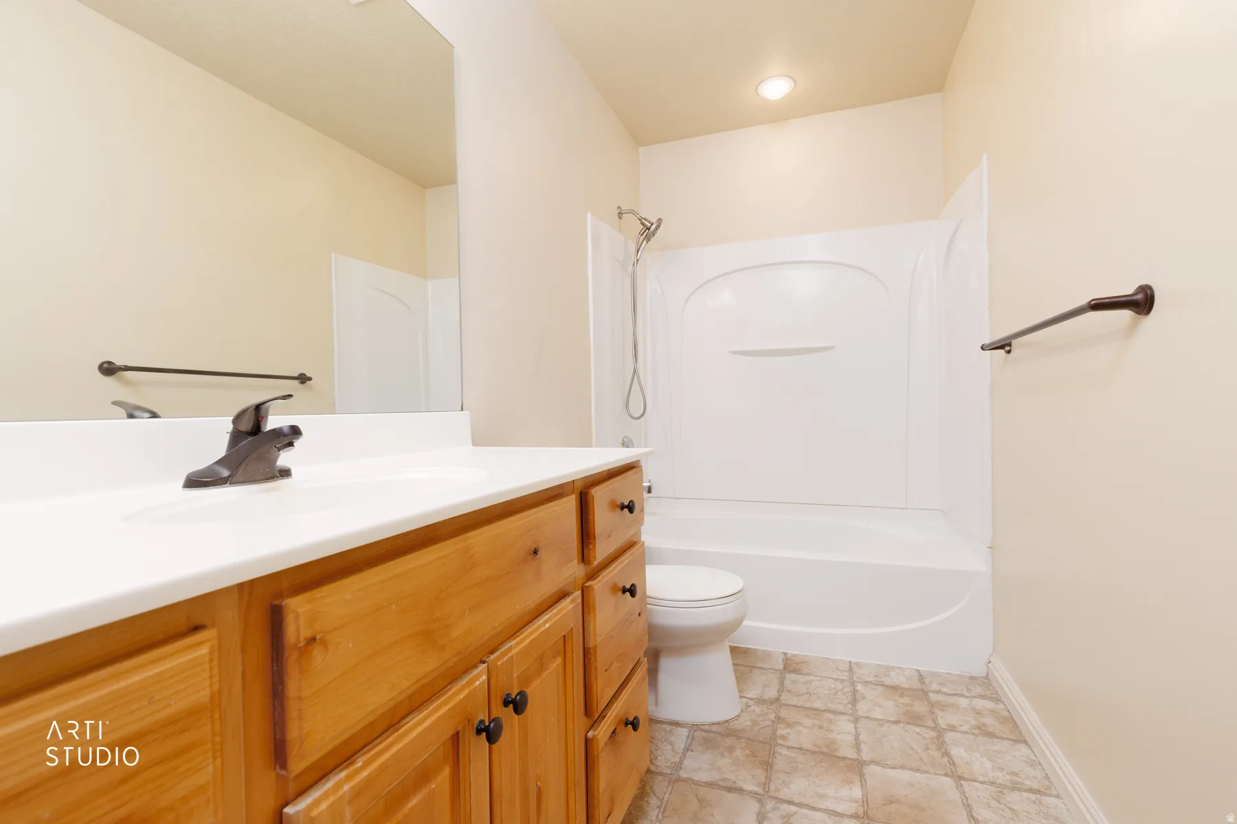 Bathroom featuring a light wood-finish vanity with a white countertop and integrated sink