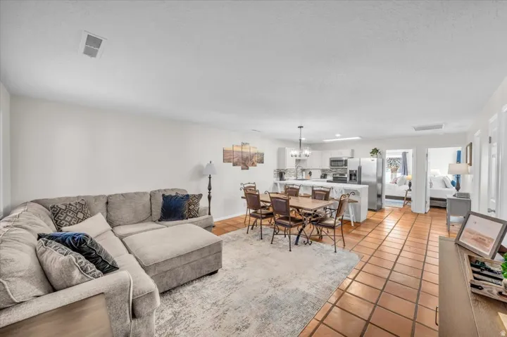 Open-concept living area with tile flooring and an integrated dining space