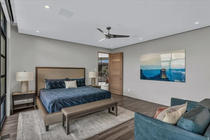Spacious room featuring wood-finish flooring, recessed lighting, and a contemporary ceiling fan