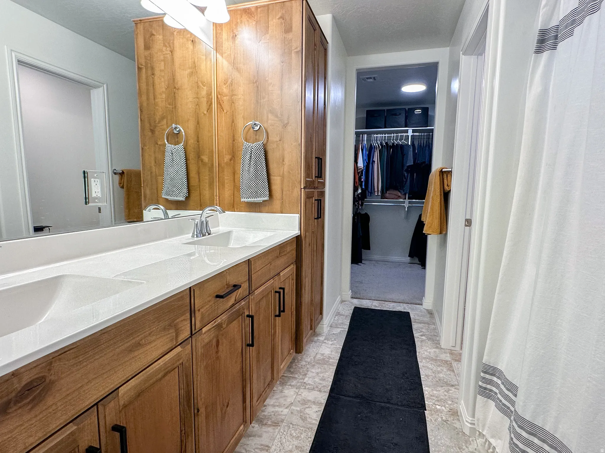 Dual vanity with undermount sinks and white countertops