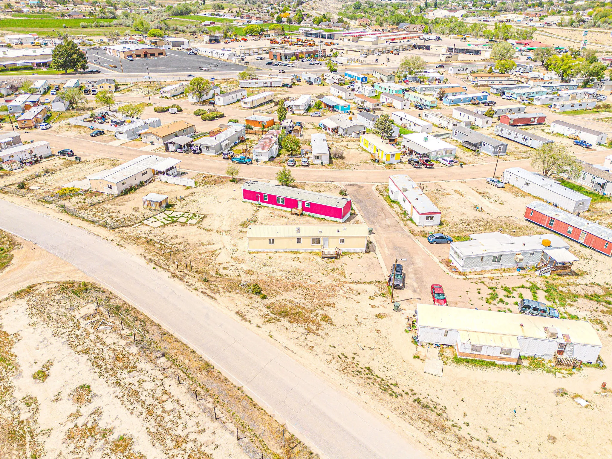 Expansive parcel featuring multiple manufactured homes, established roadways, and a surrounding arid landscape